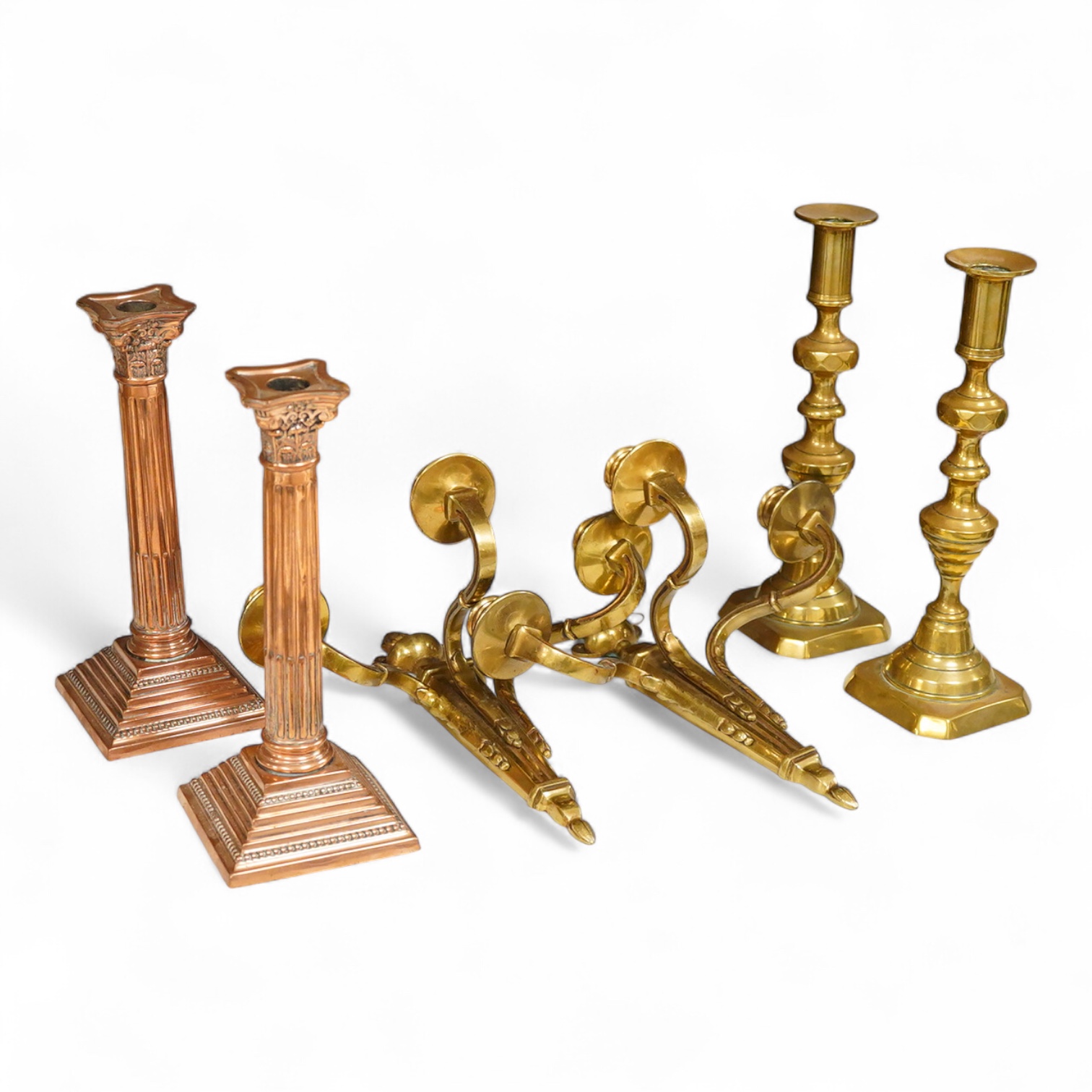 A pair of Corinthian column copper candlesticks, a pair of three branch sconces and pair of brass candlesticks, together with brass-mounted mahogany wall shelf /cabinet - 33cm high